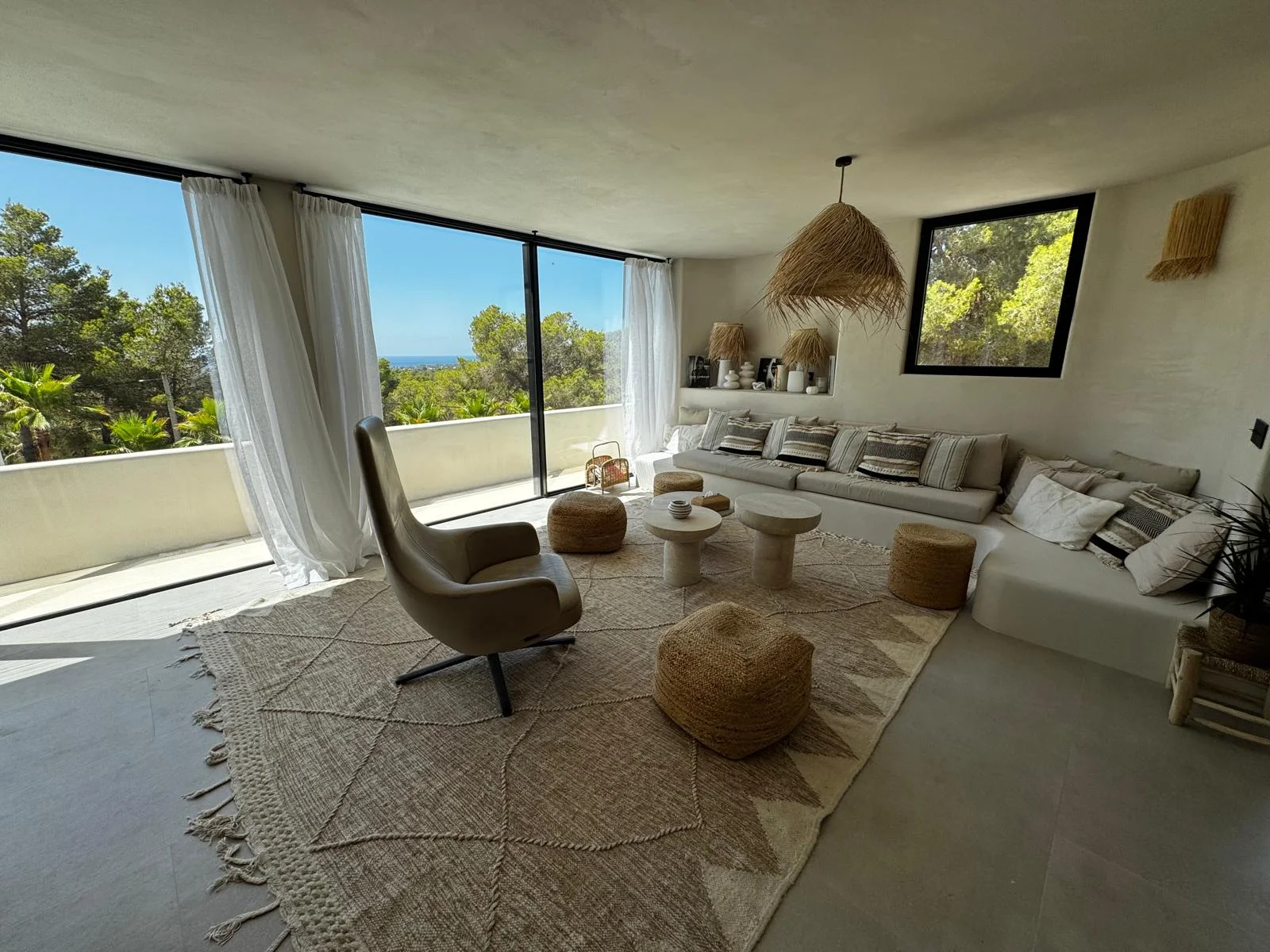 Villa renovation Ibiza — living room with sea views and microcement
